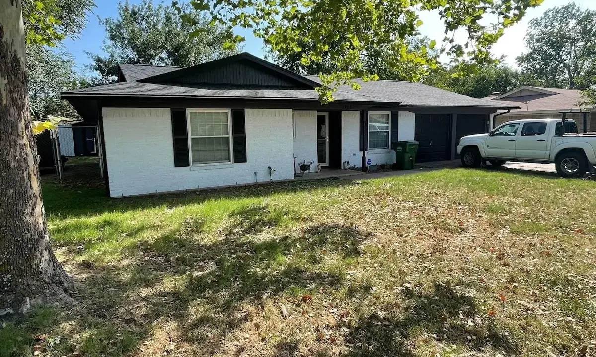 Professional roofing crew working on a residential roof in Rossford